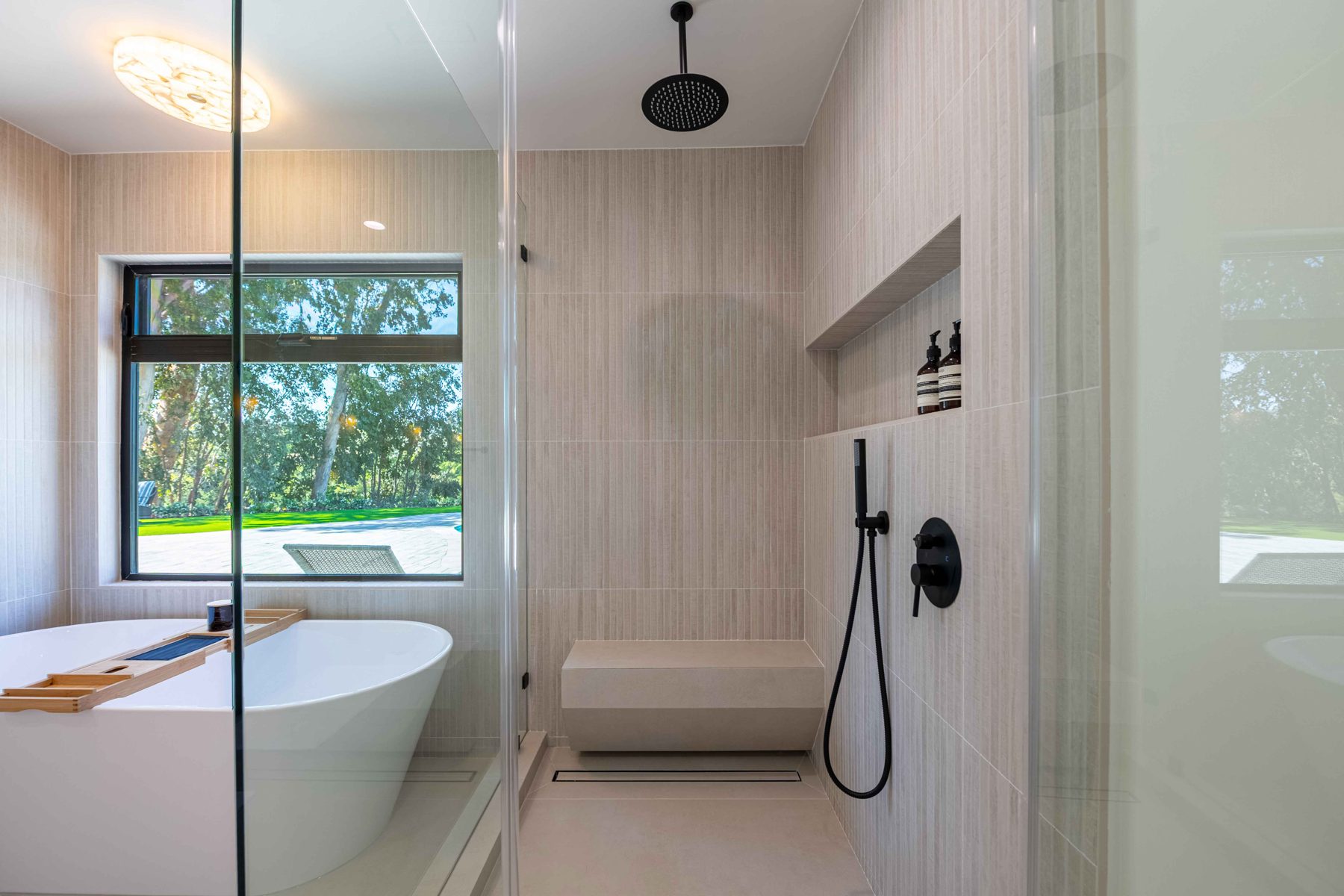 Freestanding tub and black tile shower remodel