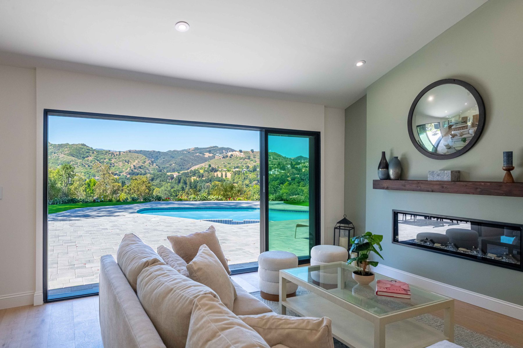 Great room with linear fireplace and canyon view