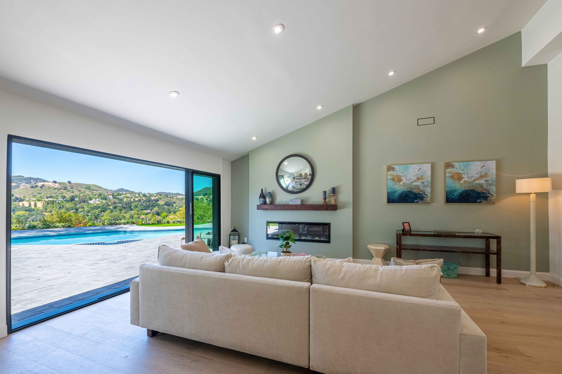 Warm, light-filled living room by Ivy Builders
